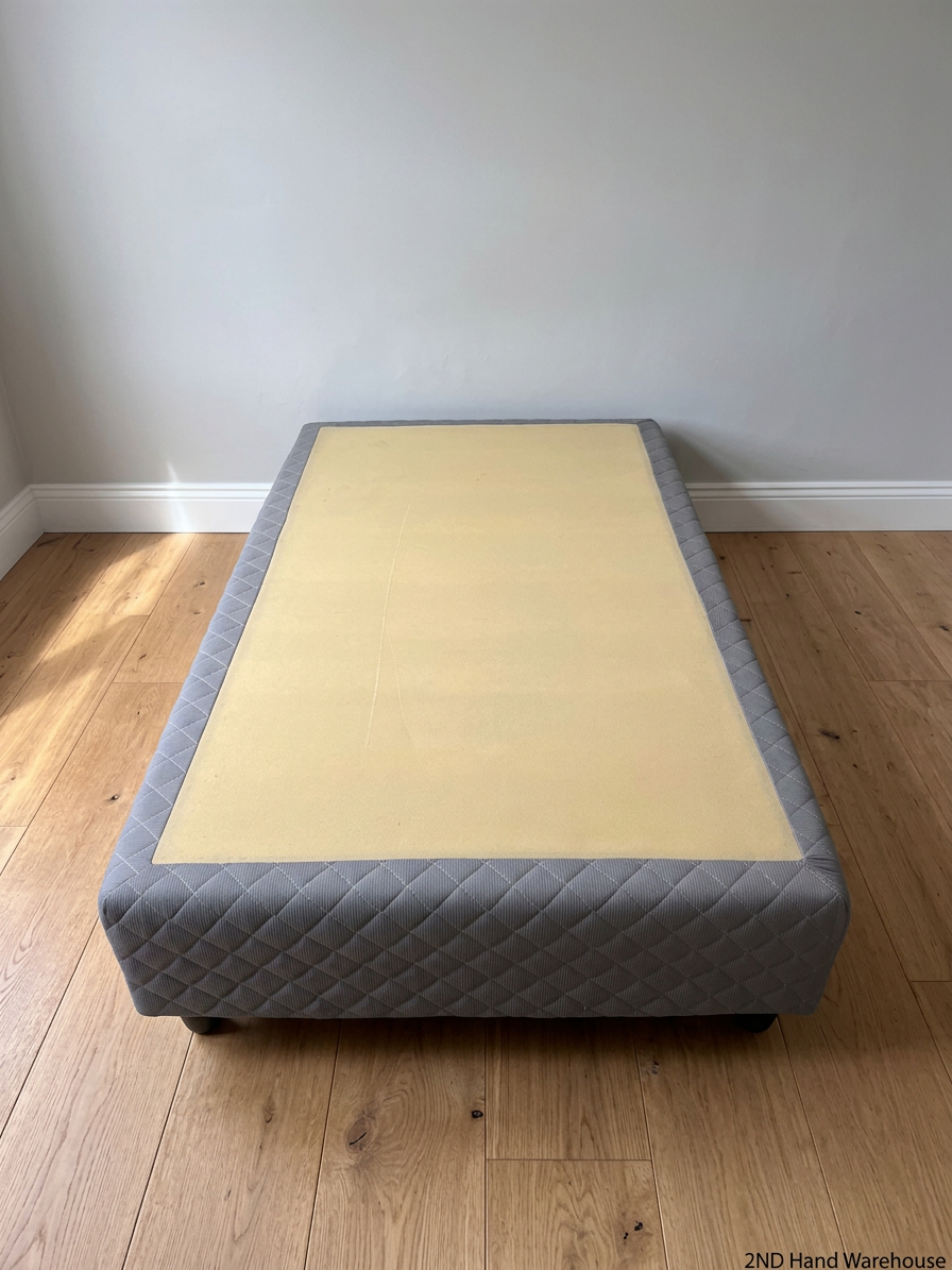 Quilted Grey Upholstered Single Bed Base — Loose Bottom Ring and Well-Used Condition – styled product image