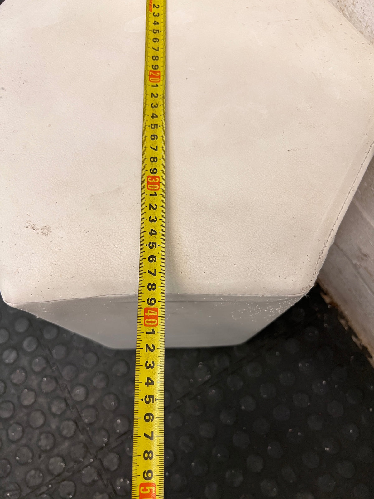 White Hexagonal Upholstered Ottoman — Aged Upholstery with Visible Wear – depth measurement