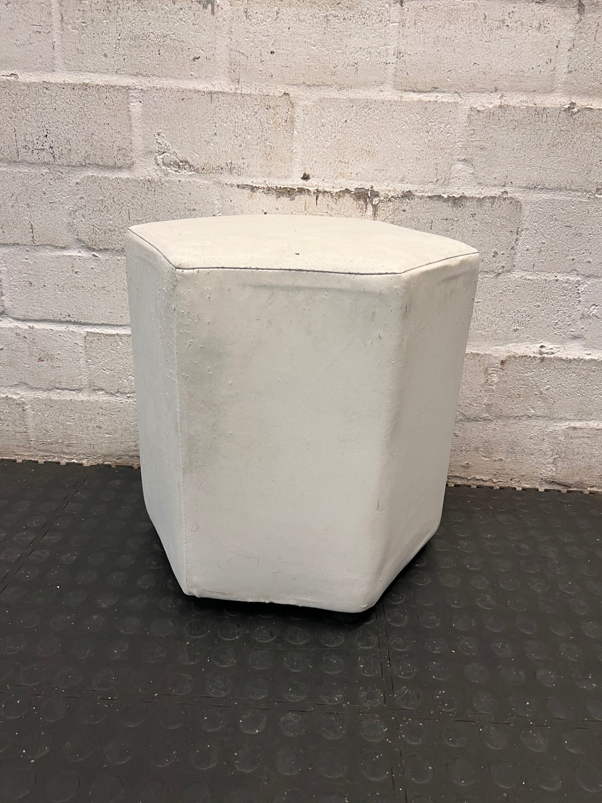 White Hexagonal Upholstered Ottoman — Aged Upholstery with Visible Wear – main front view