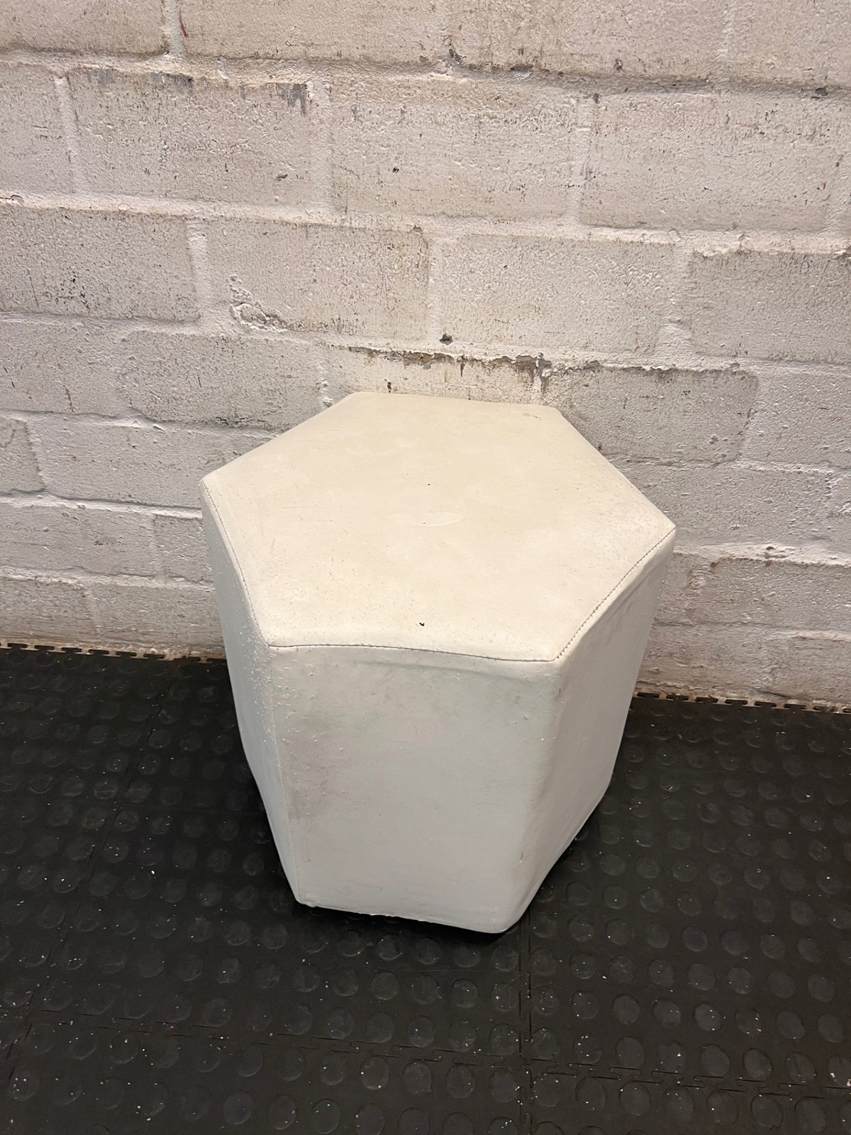 White Hexagonal Upholstered Ottoman — Aged Upholstery with Visible Wear – side view