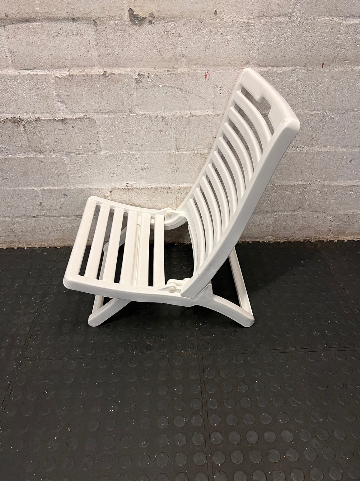 White Slatted Plastic Folding Chair – side view