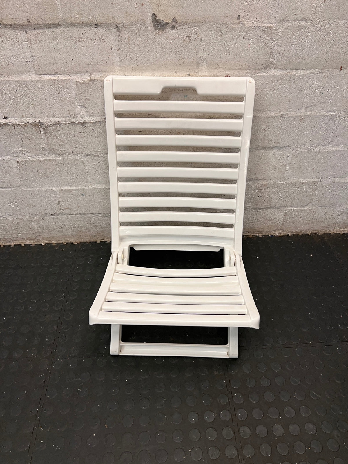 White Slatted Plastic Folding Chair – top view