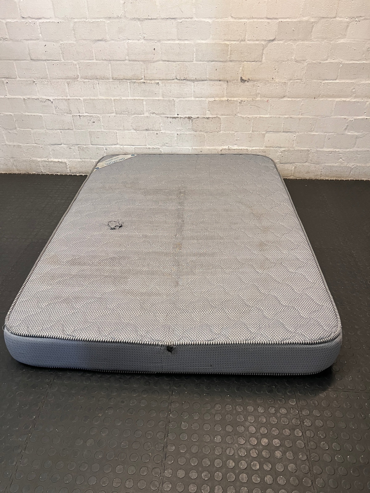 Grey Textured Double Mattress — Stained Surface with Hole in Fabric – back view