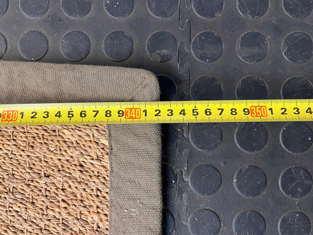 Large Woven Brown Area Rug with Fabric Border — Fair Condition with Visible Wear – depth measurement