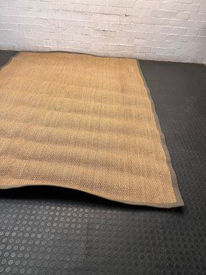 Large Woven Brown Area Rug with Fabric Border — Fair Condition with Visible Wear – side view