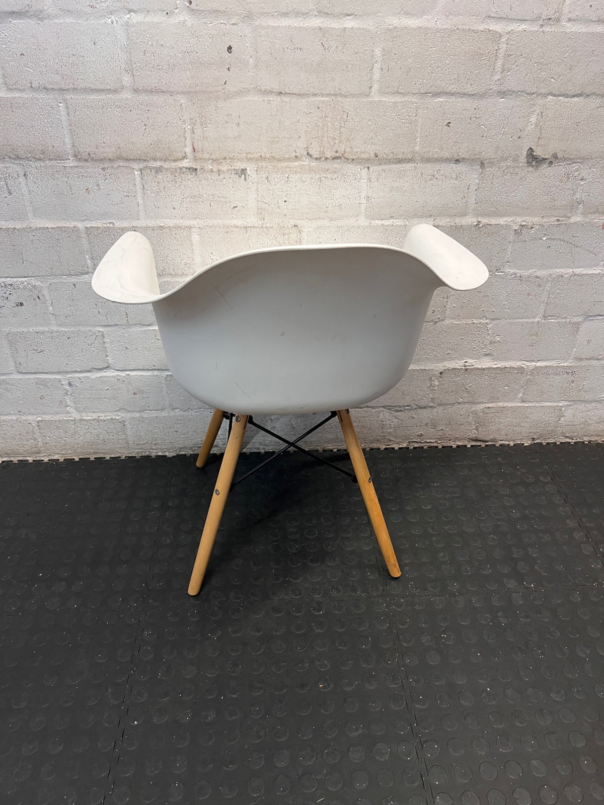 Moulded White Dining Chair with Tapered Wooden Legs — Visible Wear and Surface Marks – back view