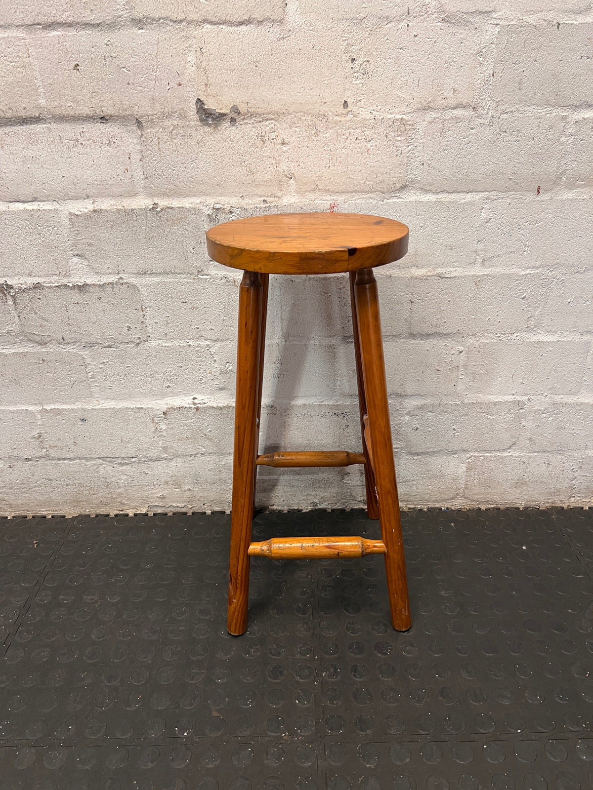 Classic Brown Wooden Bar Stool with Round Seat — Worn Condition with Structural Wear – back view