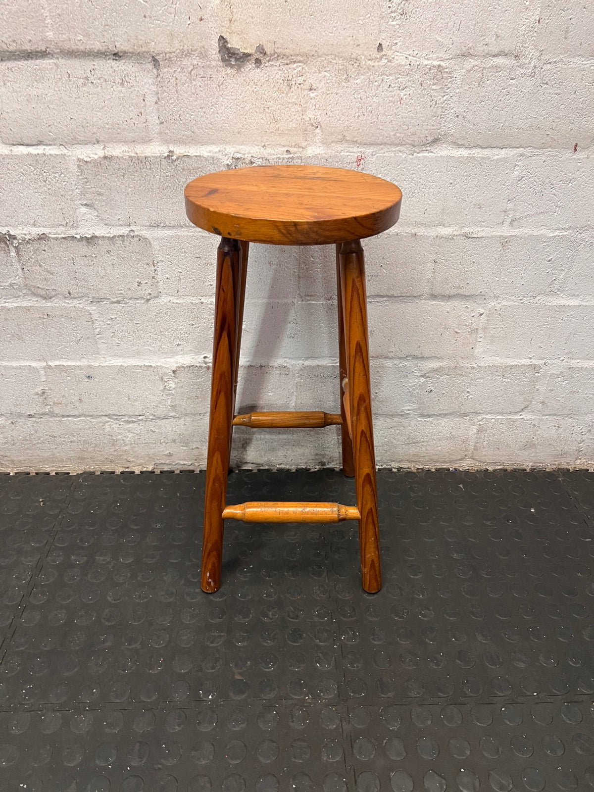 Classic Brown Wooden Bar Stool with Round Seat — Worn Condition with Structural Wear – main front view