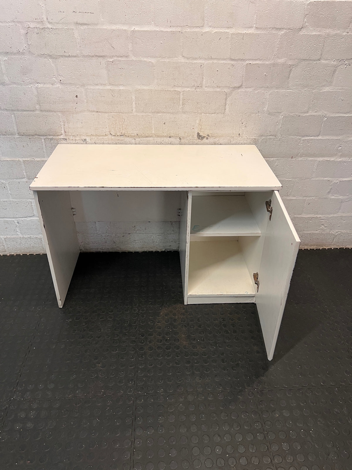 Compact White Office Desk with Right-Hand Pedestal — Visible Wear and Structural Damage – side view
