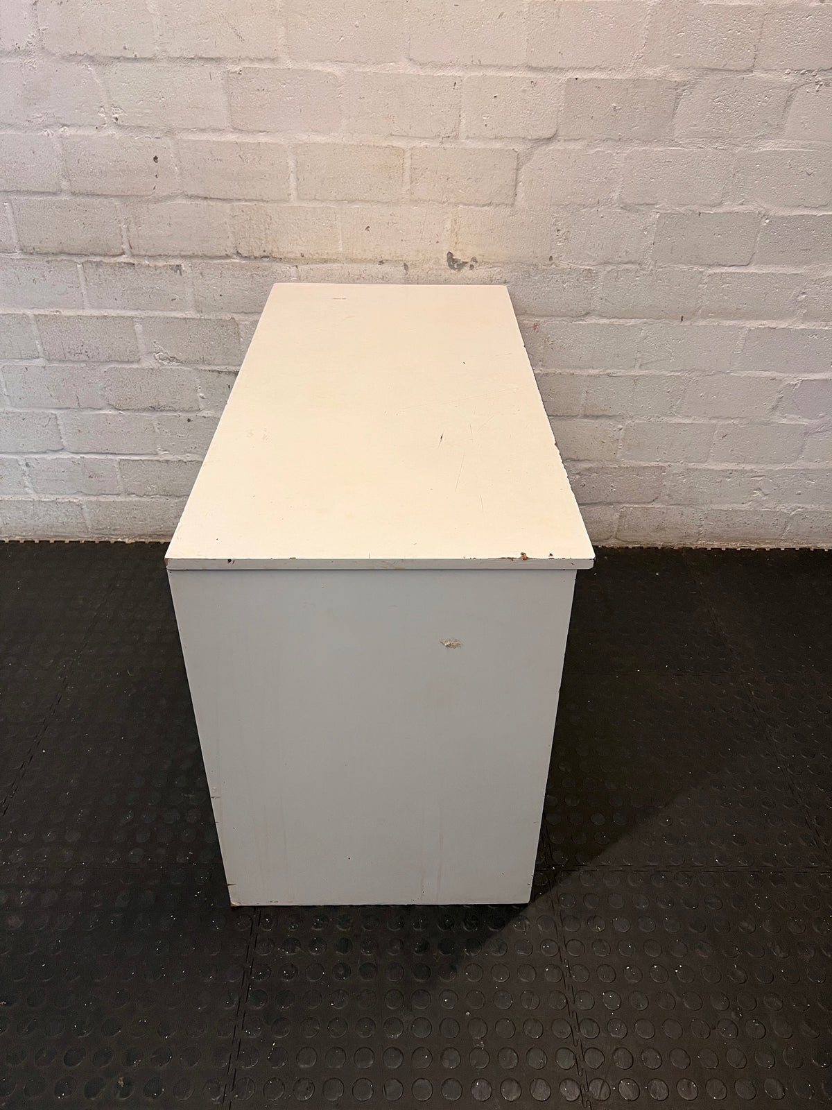 Compact White Office Desk with Right-Hand Pedestal — Visible Wear and Structural Damage – top view