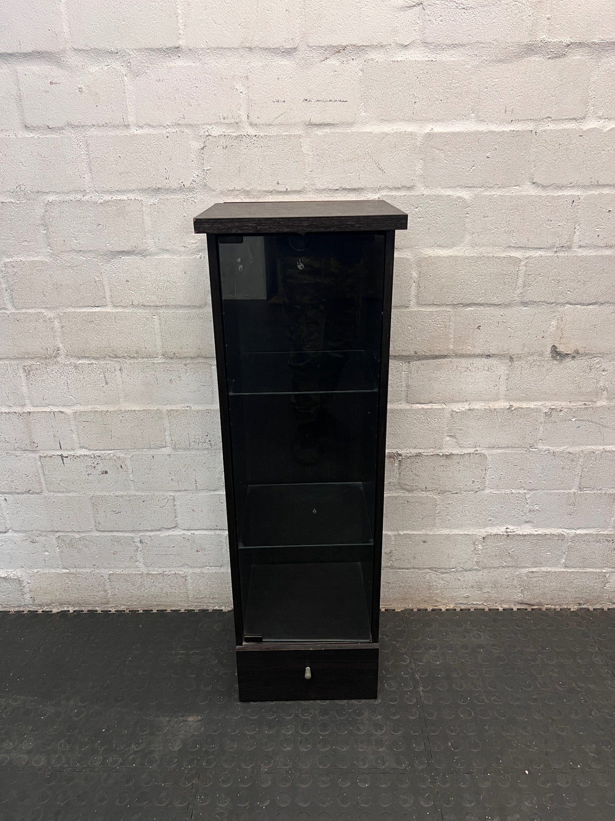 Black Slim Display Cabinet with Glass Door and Drawer — Well Used with Visible Wear – main front view