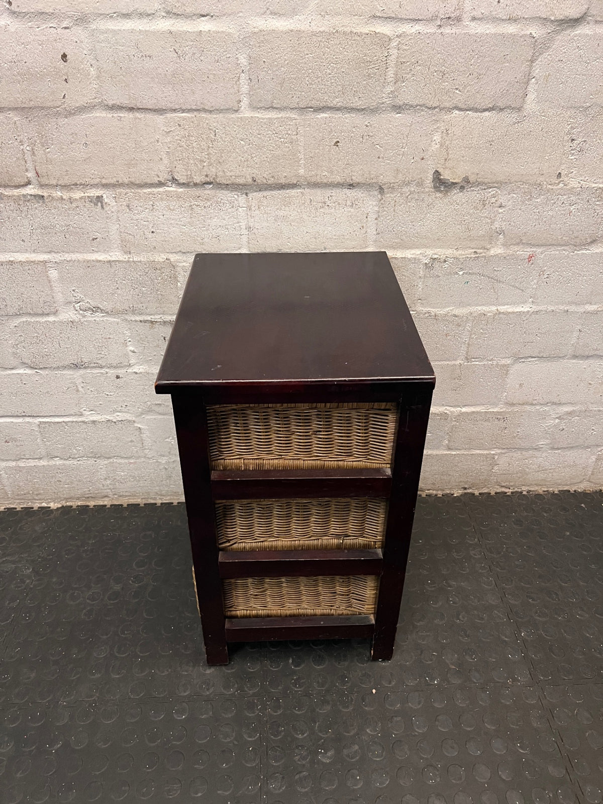 Dark Wood Bedside Table with Woven Wicker Drawers — Well Used with Visible Surface Wear – back view
