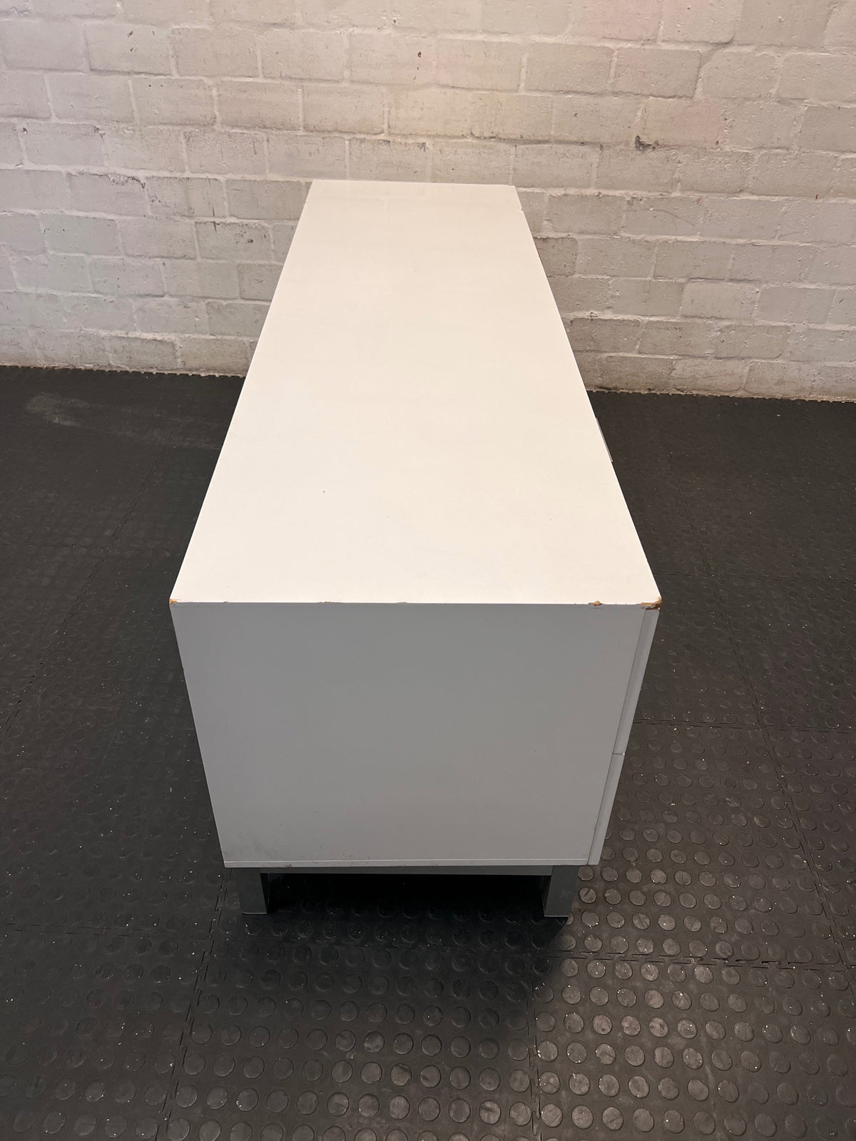 White Four-Drawer TV Unit with Metal Handles — Minor Bump Damage on Front Corners – top view