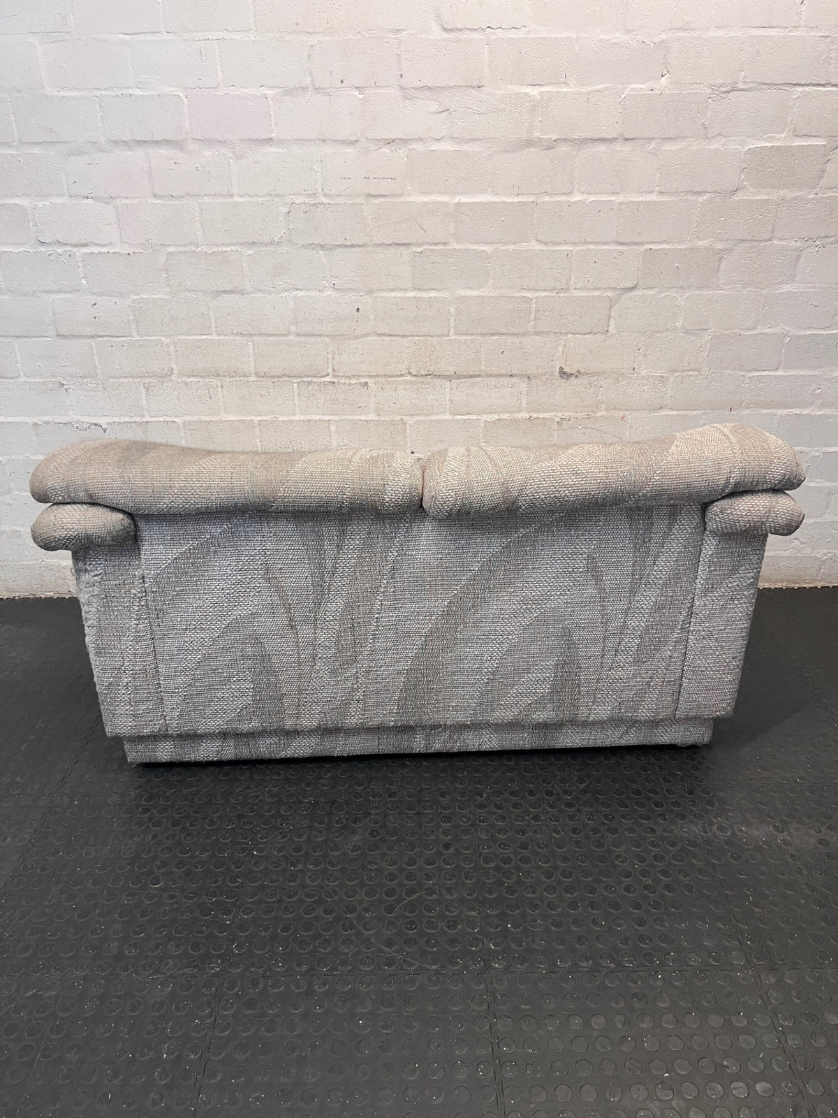 Textured Grey Patterned 2 Seater Couch — Fair Condition – back view