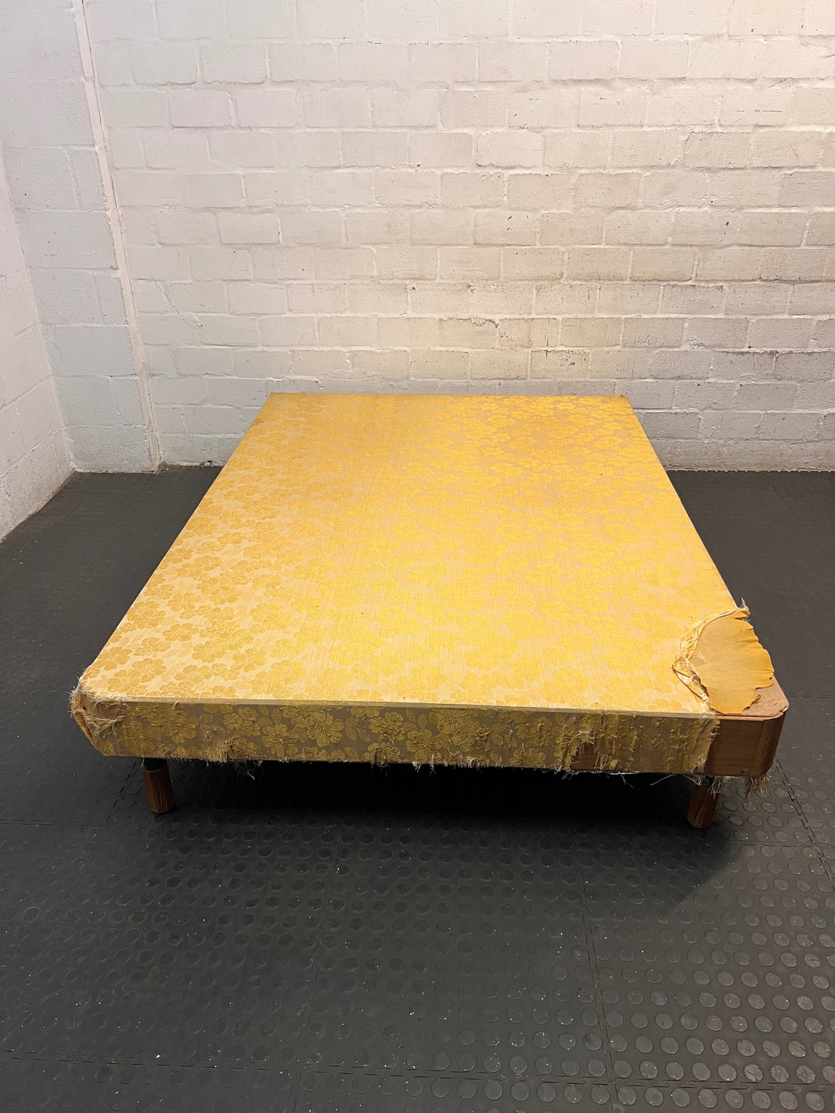 Vintage Floral Fabric Double Bed Base with Wooden Legs — Damaged Upholstery and Frayed Edges – main front view