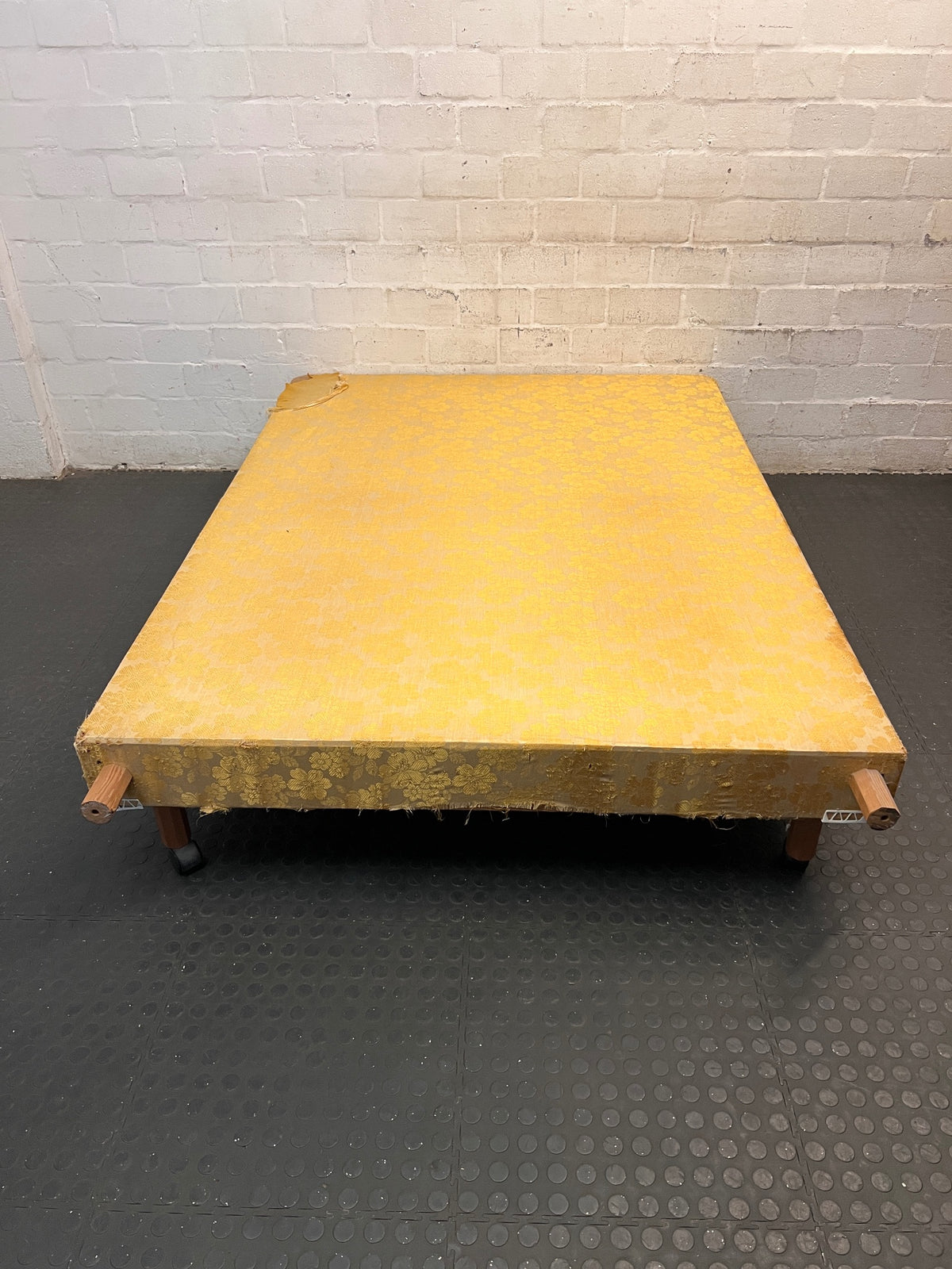 Vintage Floral Fabric Double Bed Base with Wooden Legs — Damaged Upholstery and Frayed Edges – top view
