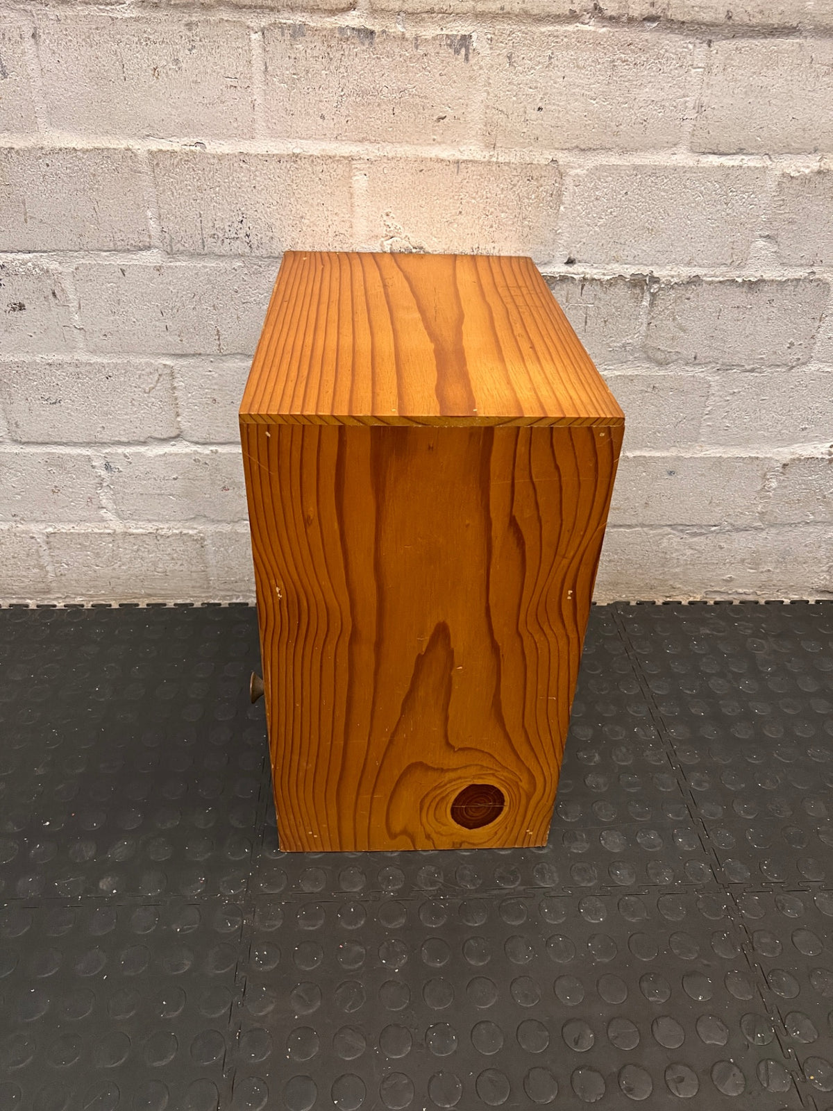 Wooden Bedside Table with Rattan-Style Door Insert — Fair Condition With Visible Wear – back view