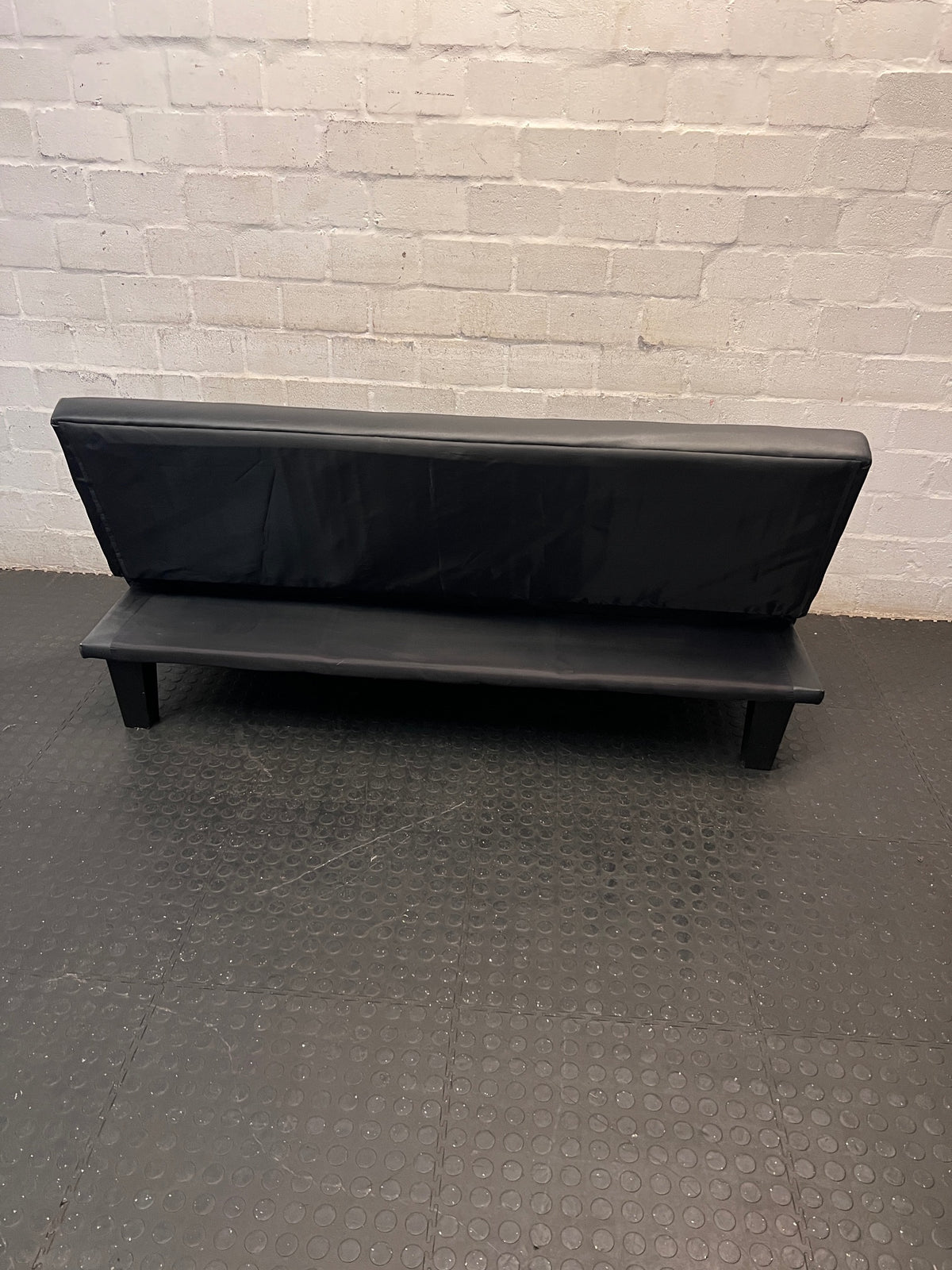 Black Tufted Leather-Look Sleeper Couch — Good Working Order – back view