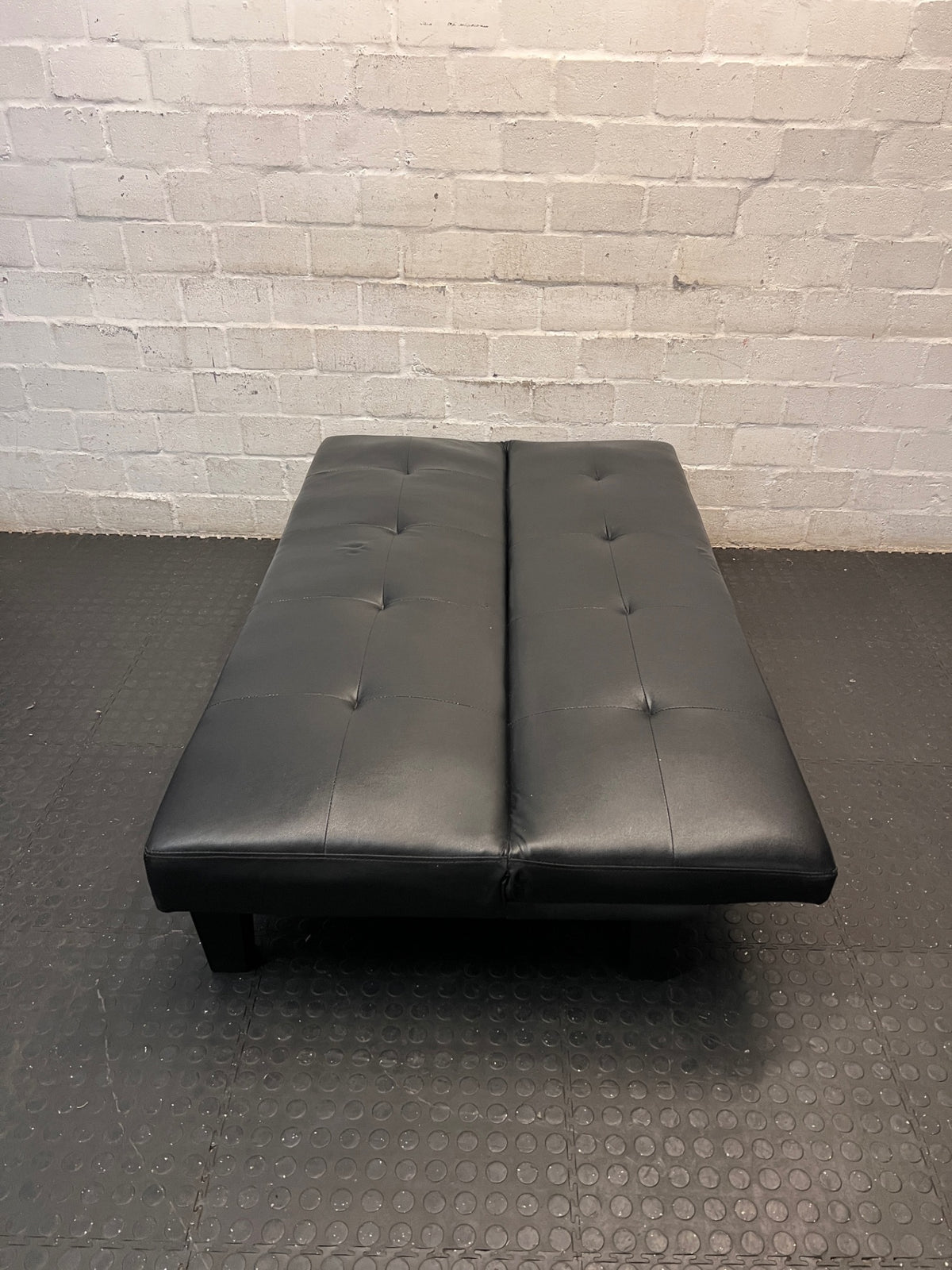 Black Tufted Leather-Look Sleeper Couch — Good Working Order – condition detail