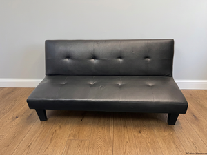 Black Tufted Leather-Look Sleeper Couch — Good Working Order – styled product image