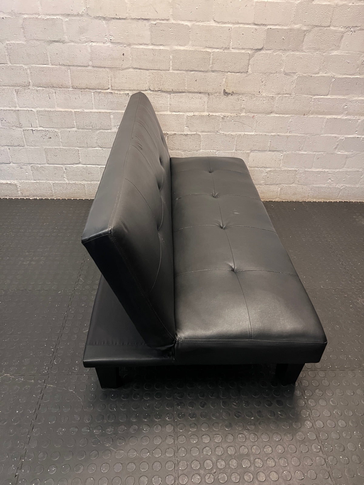 Black Tufted Leather-Look Sleeper Couch — Good Working Order – top view