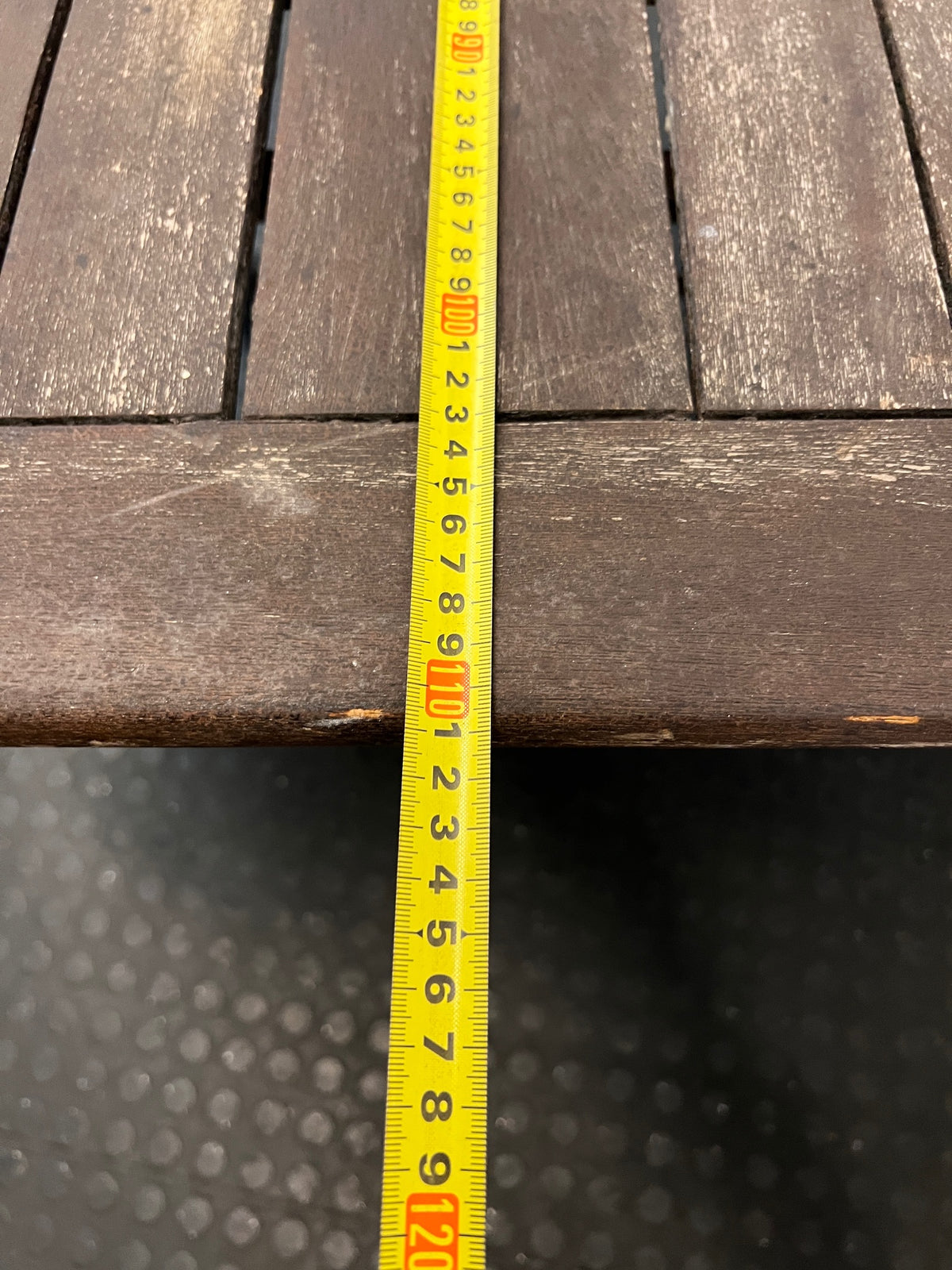 Hexagonal Slatted Wood Outdoor Table with Parasol Hole — Well Used with Faded Surface Finish – depth measurement