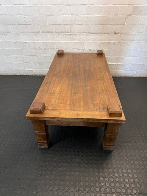 Solid Wooden Coffee Table with Carved Chunky Legs — Visible Wear Throughout – side view