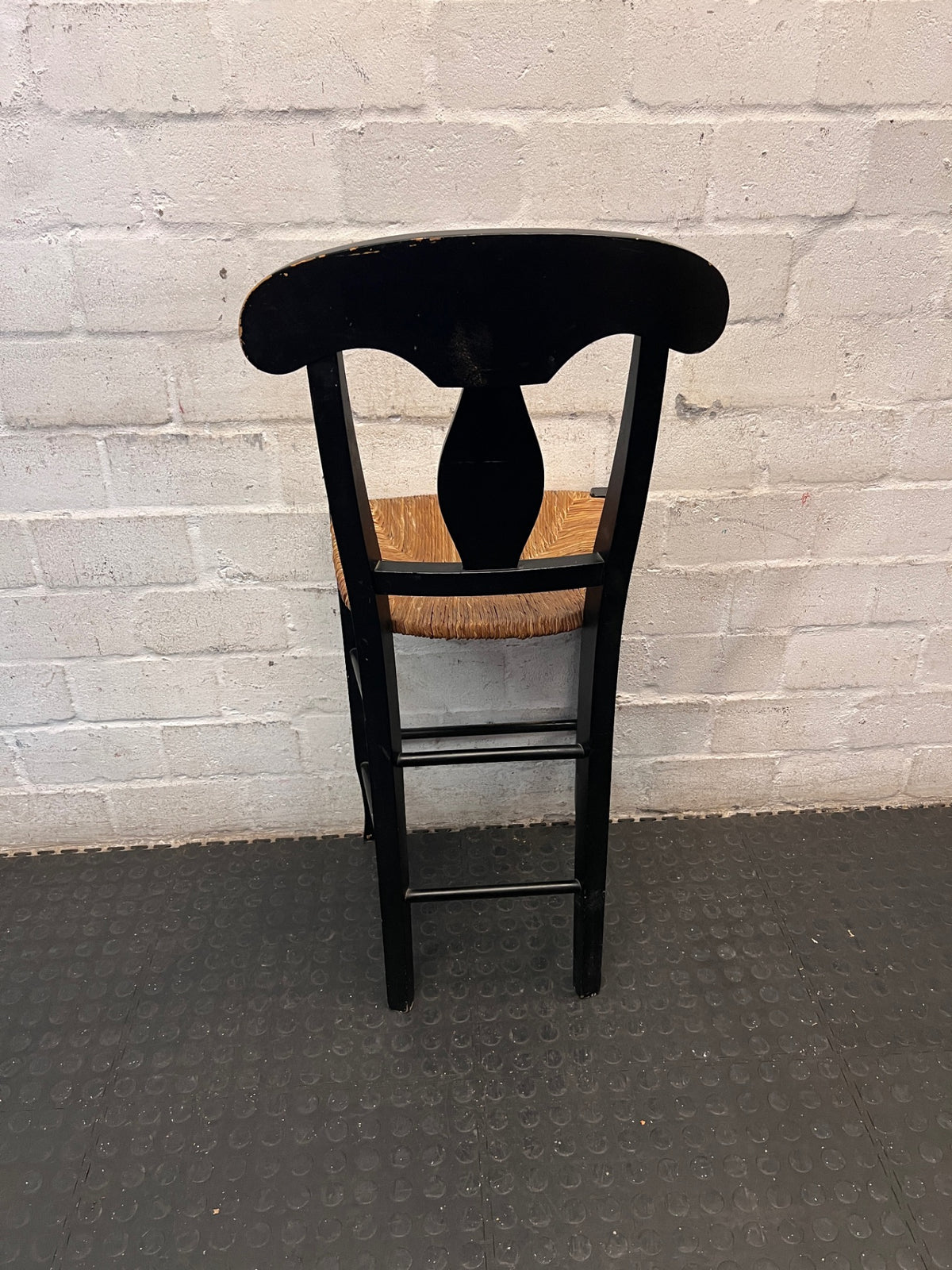Black T-Back Dining Chair with Woven Seat — Fair Condition with Visible Wear – back view