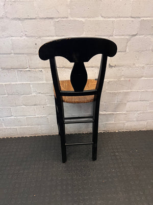 Black T-Back Dining Chair with Woven Seat — Fair Condition with Visible Wear – back view