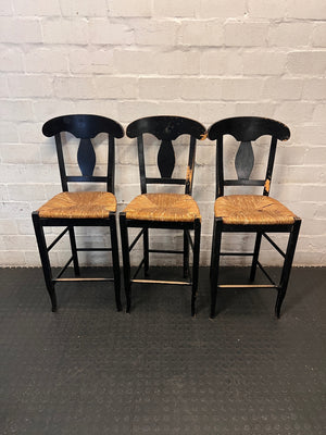Black T-Back Dining Chair with Woven Seat — Fair Condition with Visible Wear – side view