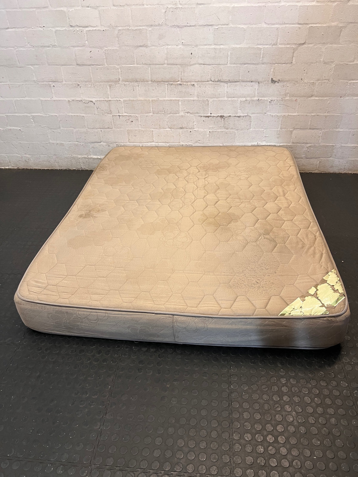 Beige Quilted Double Bed Mattress — Heavy Staining and Torn Corner Fabric – main front view