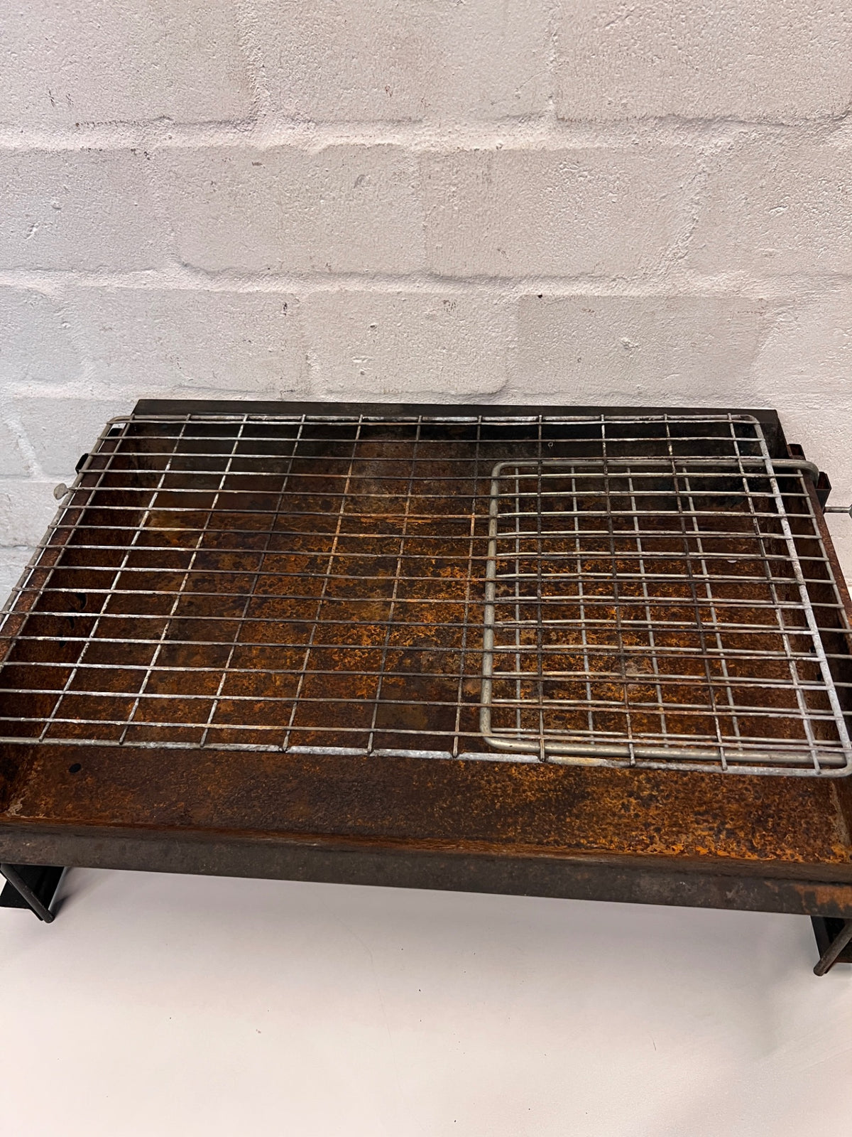 Compact Metal Wood-Burning Braai Stand with Grid — Significant Surface Rust and Heavy Wear – back view