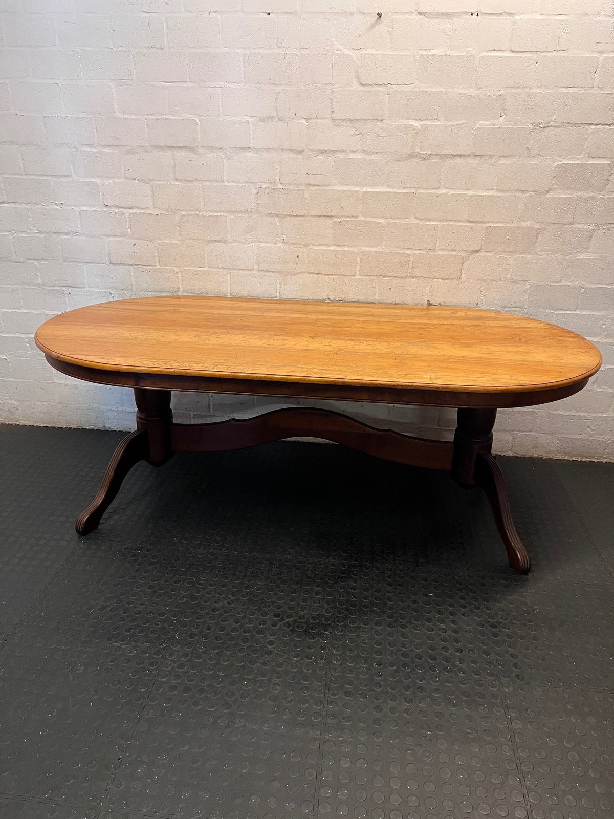 Oval Two-Tone Wooden Dining Table with Trestle Base — Good Working Order with Additional Items Included – back view