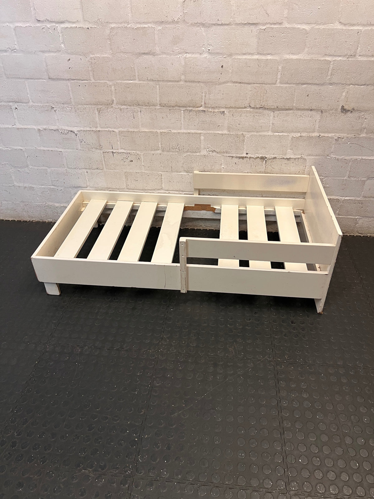 White Wooden Toddler Bed Frame with Slatted Base — Significant Wear and Missing Slats – side view