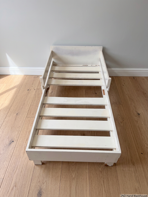 White Wooden Toddler Bed Frame with Slatted Base — Significant Wear and Missing Slats – styled product image