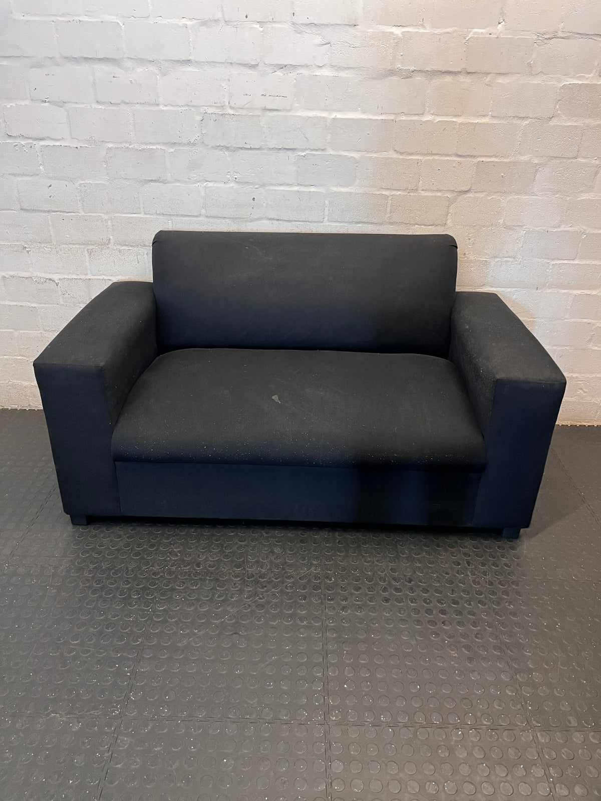 Black Synthetic Polyester 2 Seater Couch — Stains on Material; Good Functionality – main front view