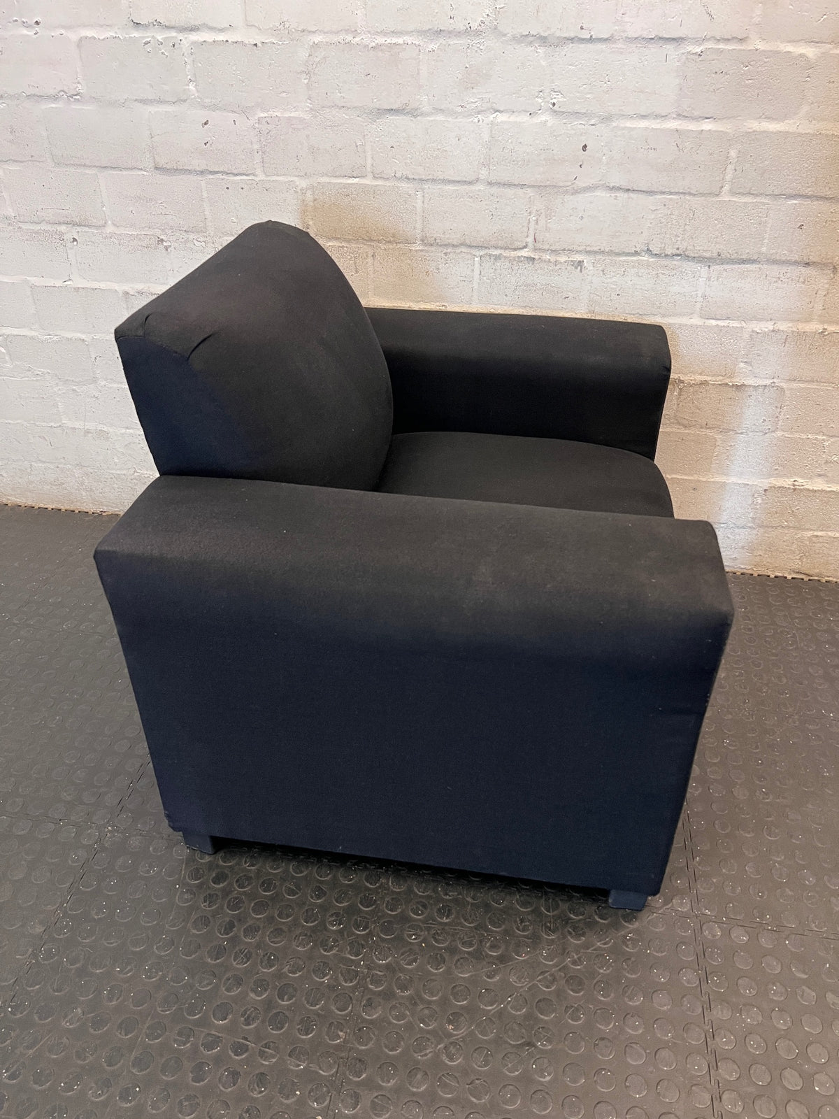 Black Synthetic Polyester 1 Seater Couch — Stains on Material; Intact Structure – back view