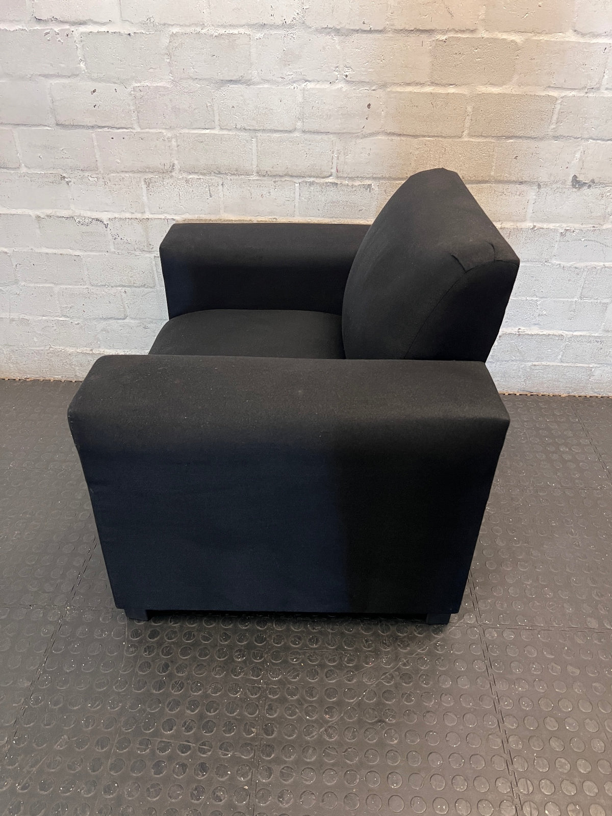 Black Synthetic Polyester 1 Seater Couch — Stains on Material; Intact Structure – side view
