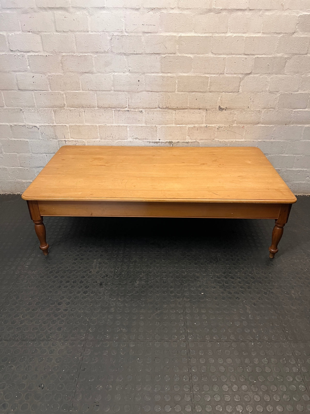 Large Honey-Toned Wooden Coffee Table with Turned Legs – main front view
