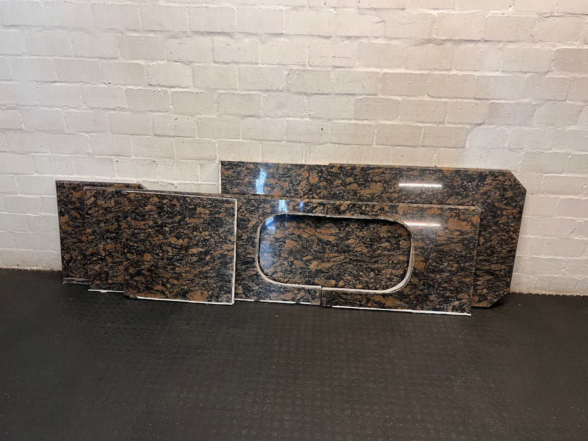Polished Brown Mottled Stone Countertop with Sink Cutout – back view