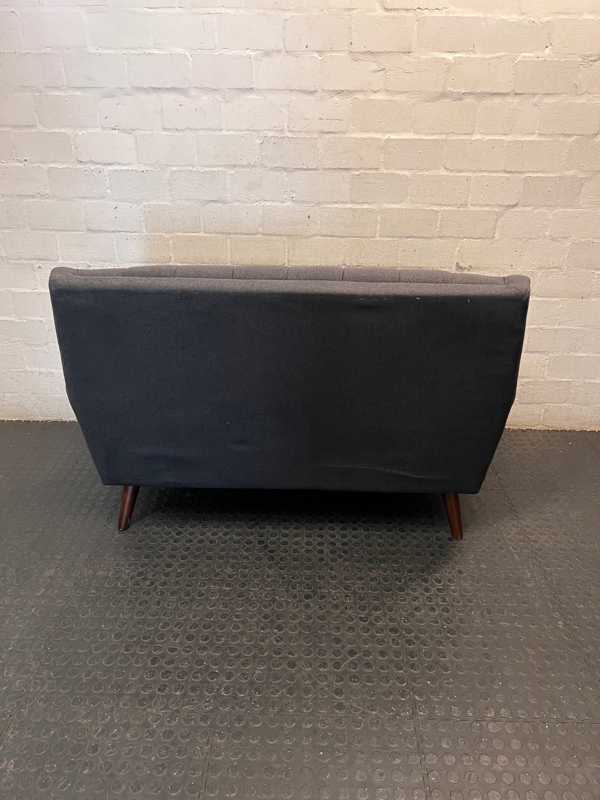 Grey Tufted Fabric 2 Seater Couch with Wooden Legs — Good with Minor Wear and Tear – condition detail