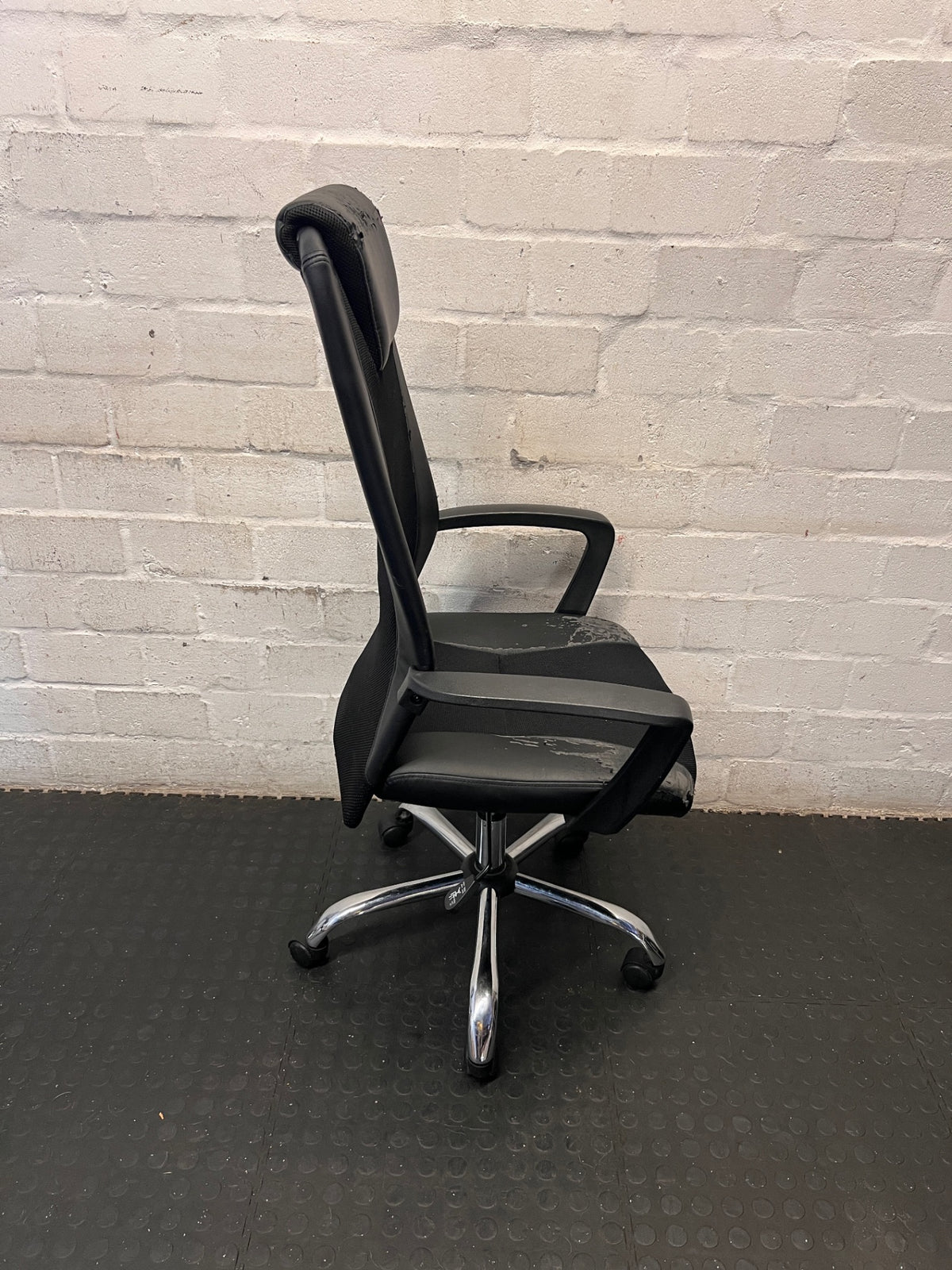 Black High-Back Office Chair with Mesh and Chrome Base — Damaged Upholstery – top view