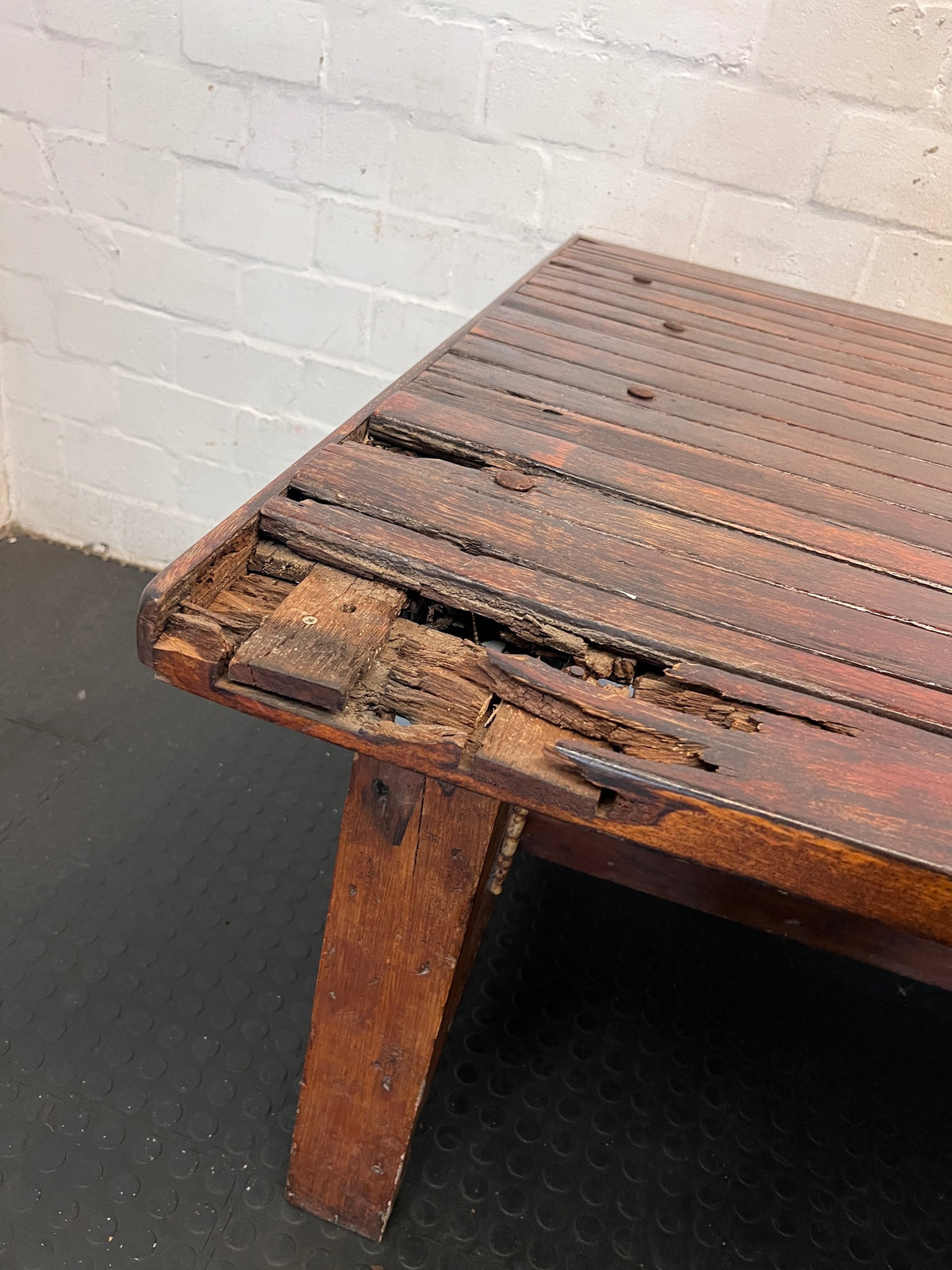 Large Dark Varnished Wood Outdoor Table — Broken Leg Join and Structural Damage – back view