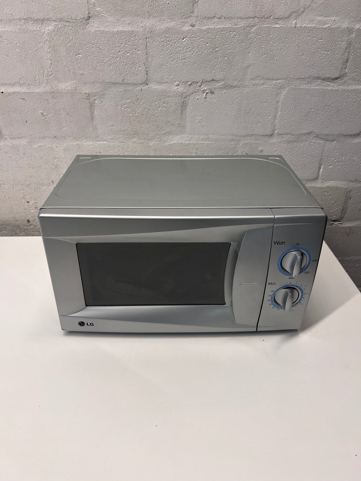 LG Silver Countertop Microwave with Manual Dials — Working but Plate Does Not Rotate – main front view