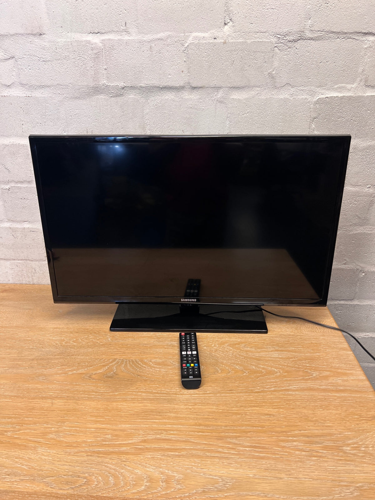 Samsung Flat Screen TV with Remote and Stand — Does Not Power On; No Power LED Indicator – top view