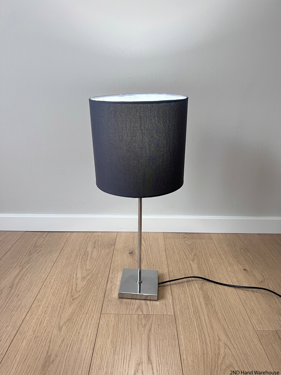 Modern Chrome Table Lamp with Black Drum Shade – styled product image