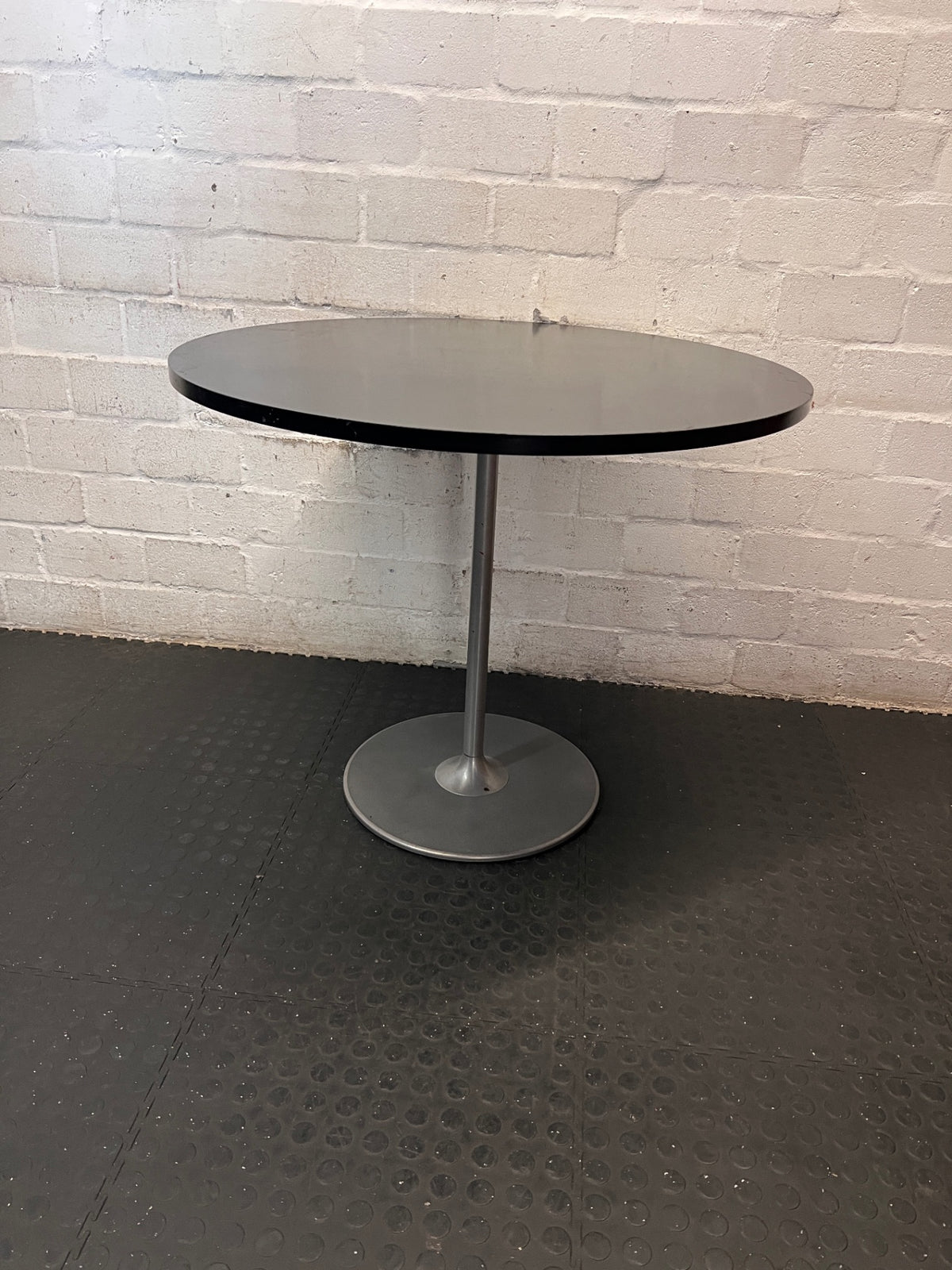 Round Black Table with Metallic Pedestal Base – back view