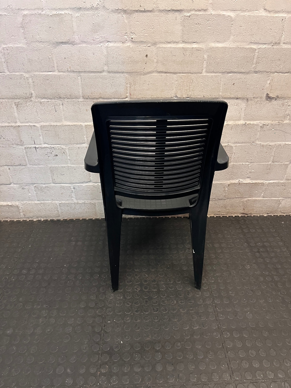 Black Plastic Outdoor Armchair – back view