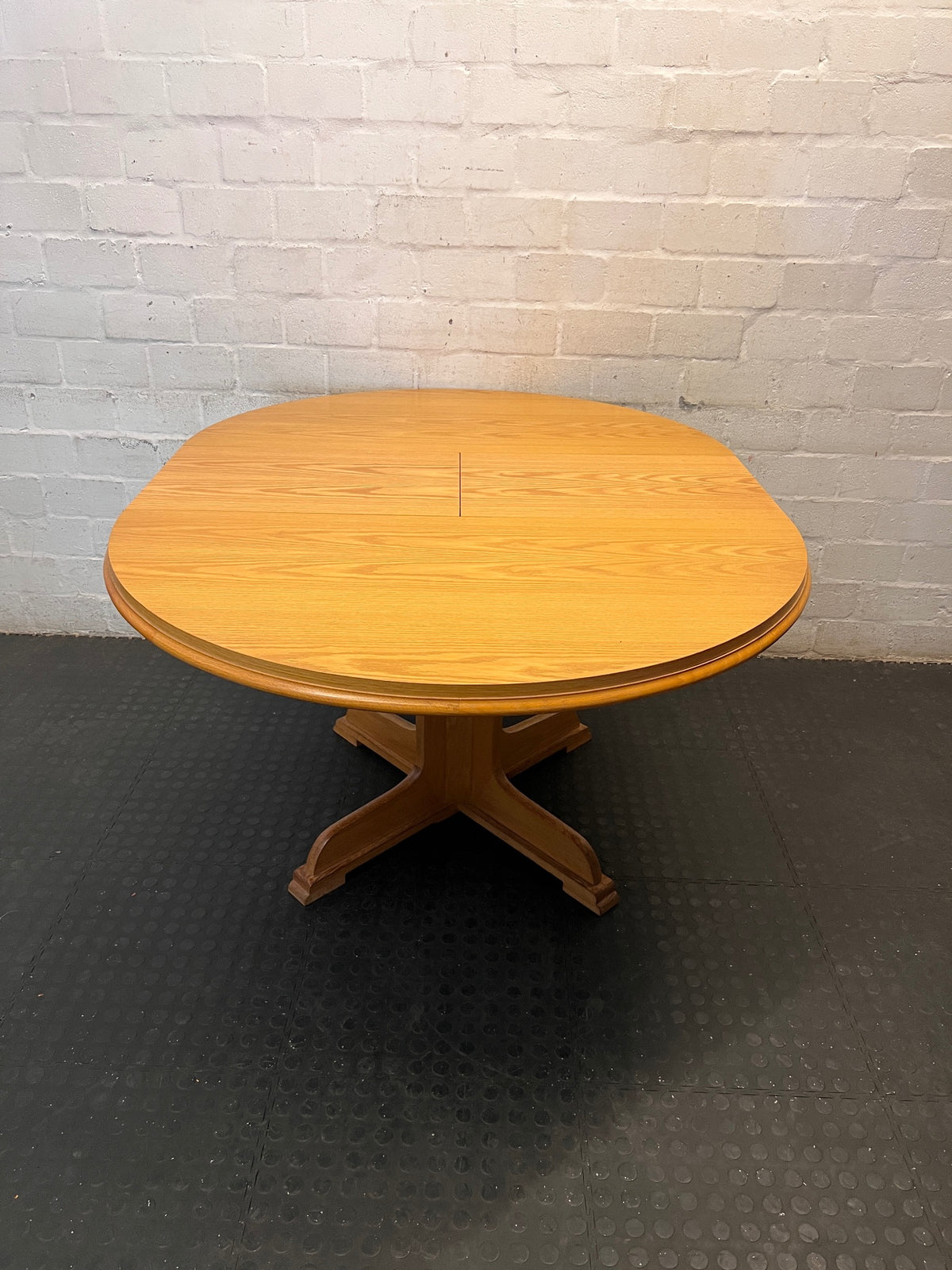 Round Wood-Finish Pedestal Dining Table – back view