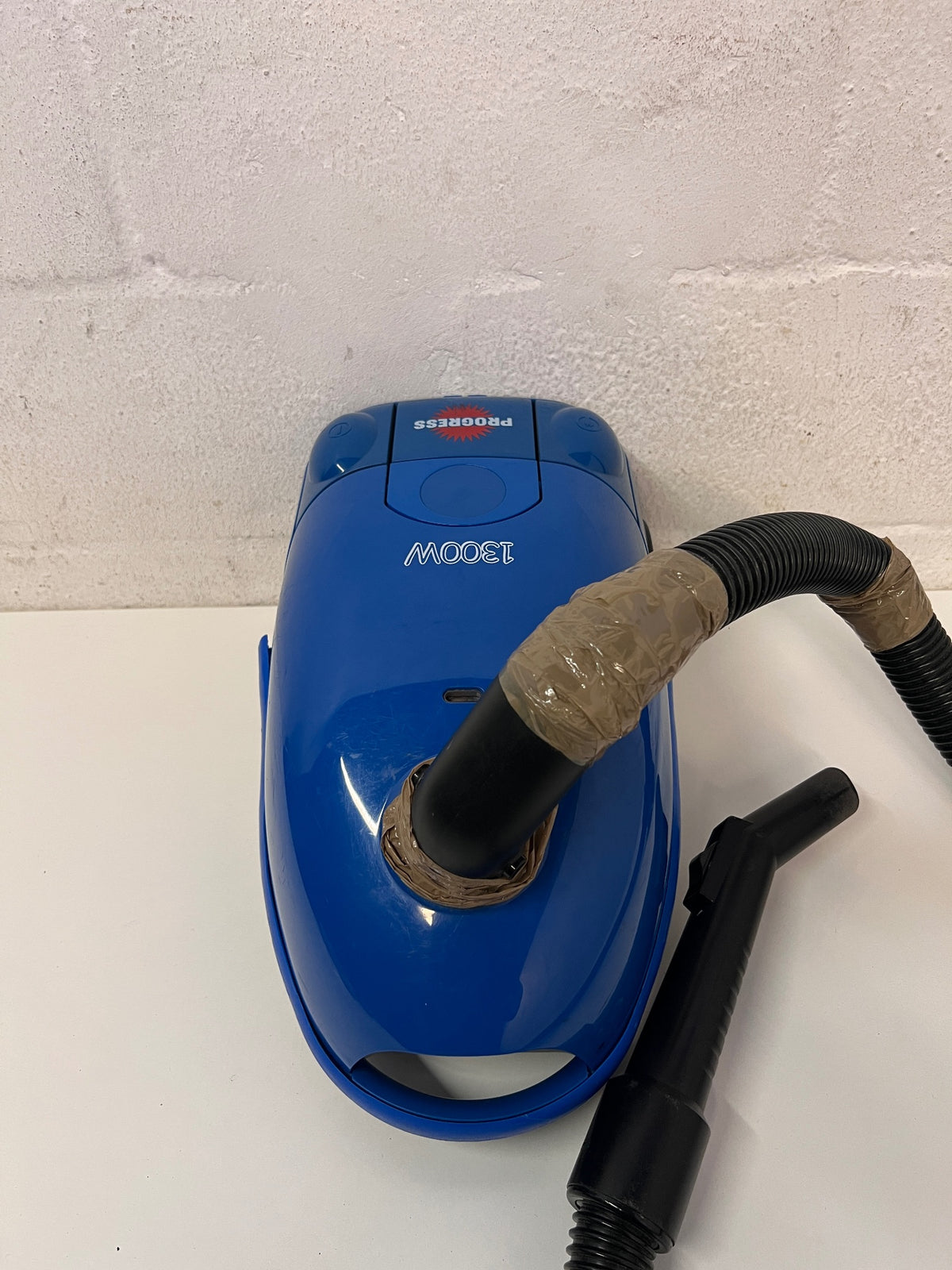 Blue Canister Vacuum Cleaner with Attachments – back view